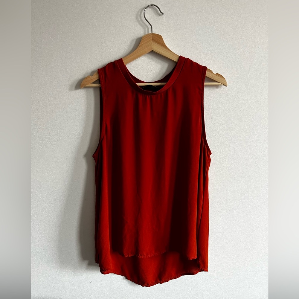 Deep orange flowy sleeveless blouse with crew neck collar